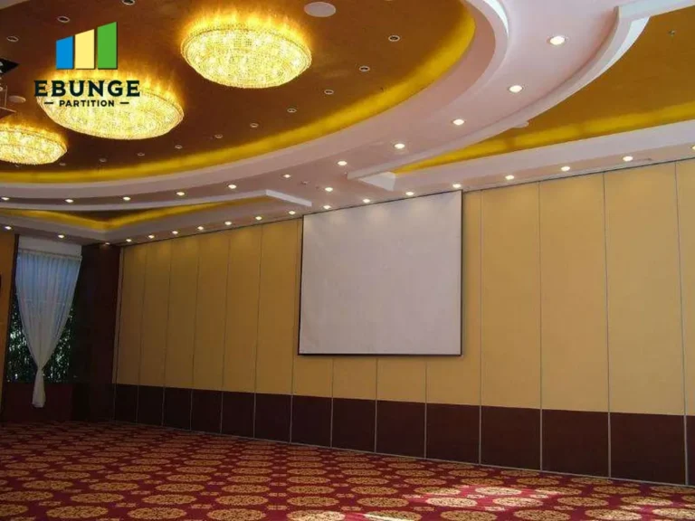 top-hung operable partition in a school hall with acoustic panels