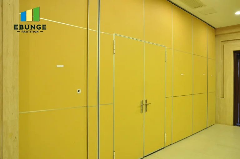 architect reviewing operable wall installation requirements for office meeting room