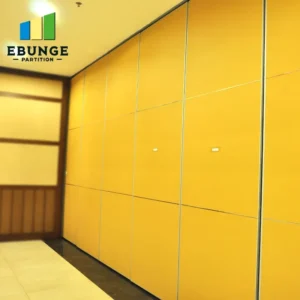 Yellow wall-to-wall storage cabinets with silver trim lining a hallway; EBUNGE PARTITION logo visible in the top-left corner.