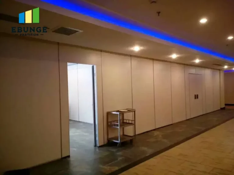 office operable wall supplier inspecting acoustic movable wall in conference room