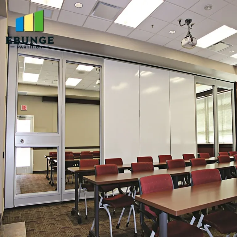 glass sliding partitions in a school hall with acoustic panels