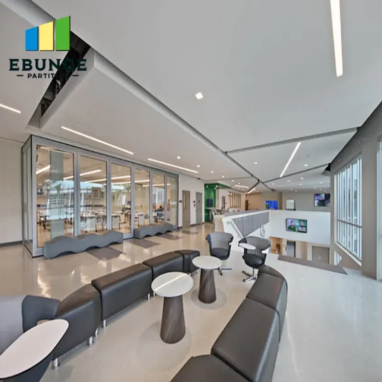 of a modern office meeting room with glass sliding partitions and acoustic panels
