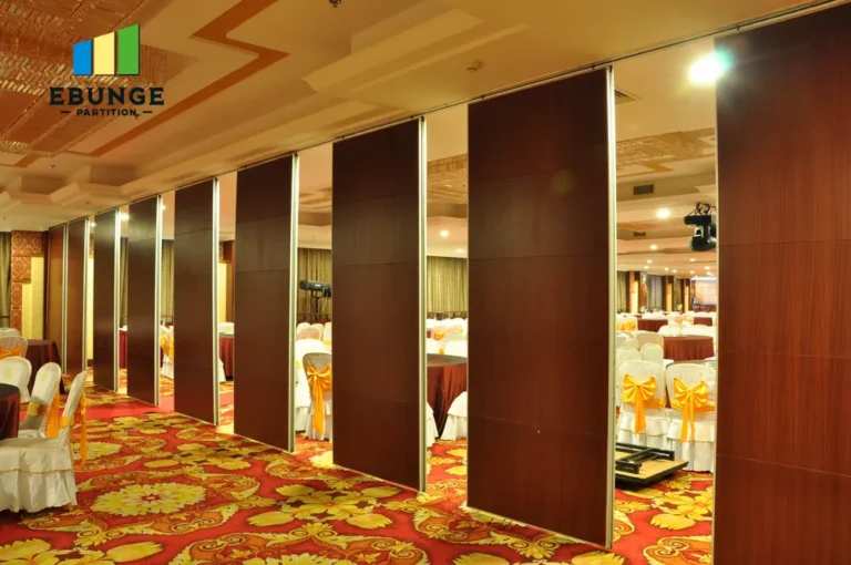 of a movable partition system in a school hall, showing acoustic panels and top-hung
