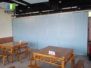 movable partition wall in a school hall with acoustic panels and top-hung track