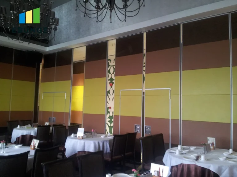 sliding wall system in a school hall with acoustic panels