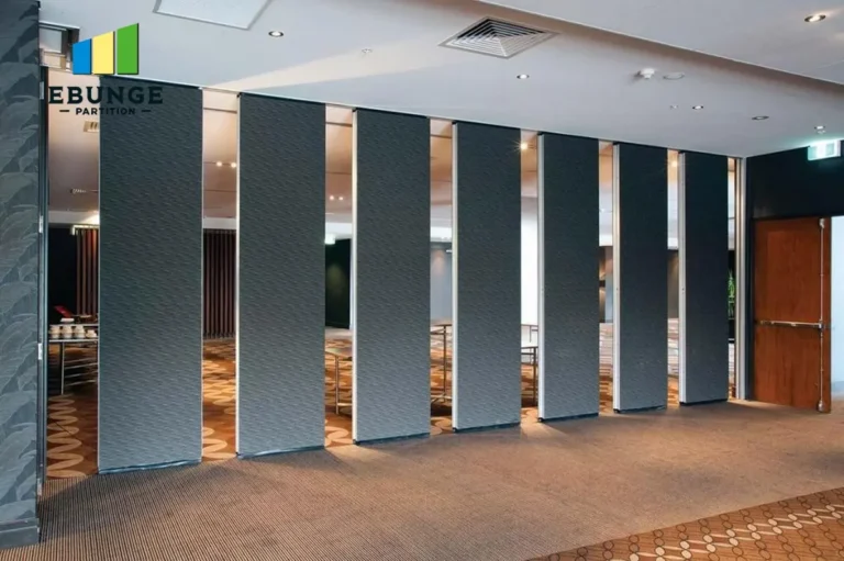 architect assessing commercial movable partition wall in school hall