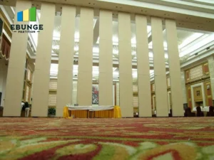 architect reviewing movable partition stacking layout in office meeting room