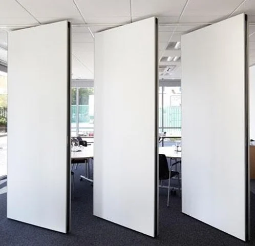 White movable partition panels separating an office interior