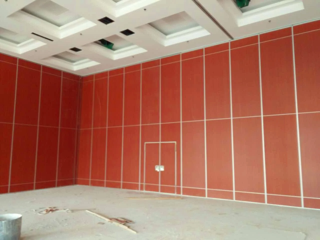Closed red-finish movable partition wall in a large room