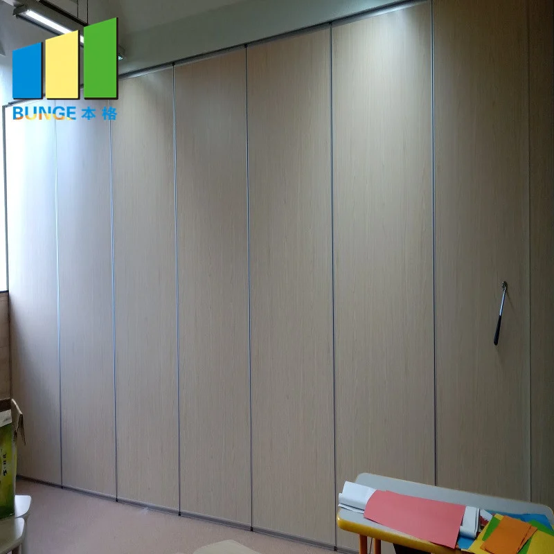 Closed wood-finish movable partition wall in a compact room