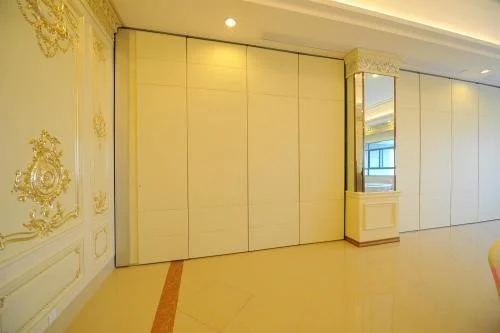 Closed light-finish movable partition wall in an ornate interior