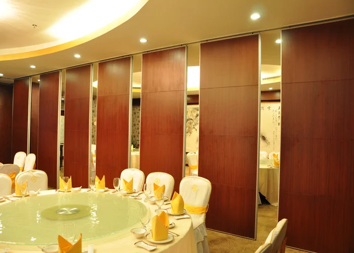 Partially opened wood-finish movable partition panels in a banquet room