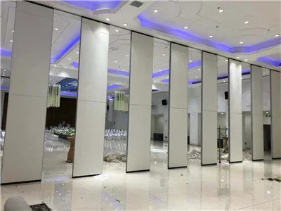 Movable partition panels opening across a museum gallery event space