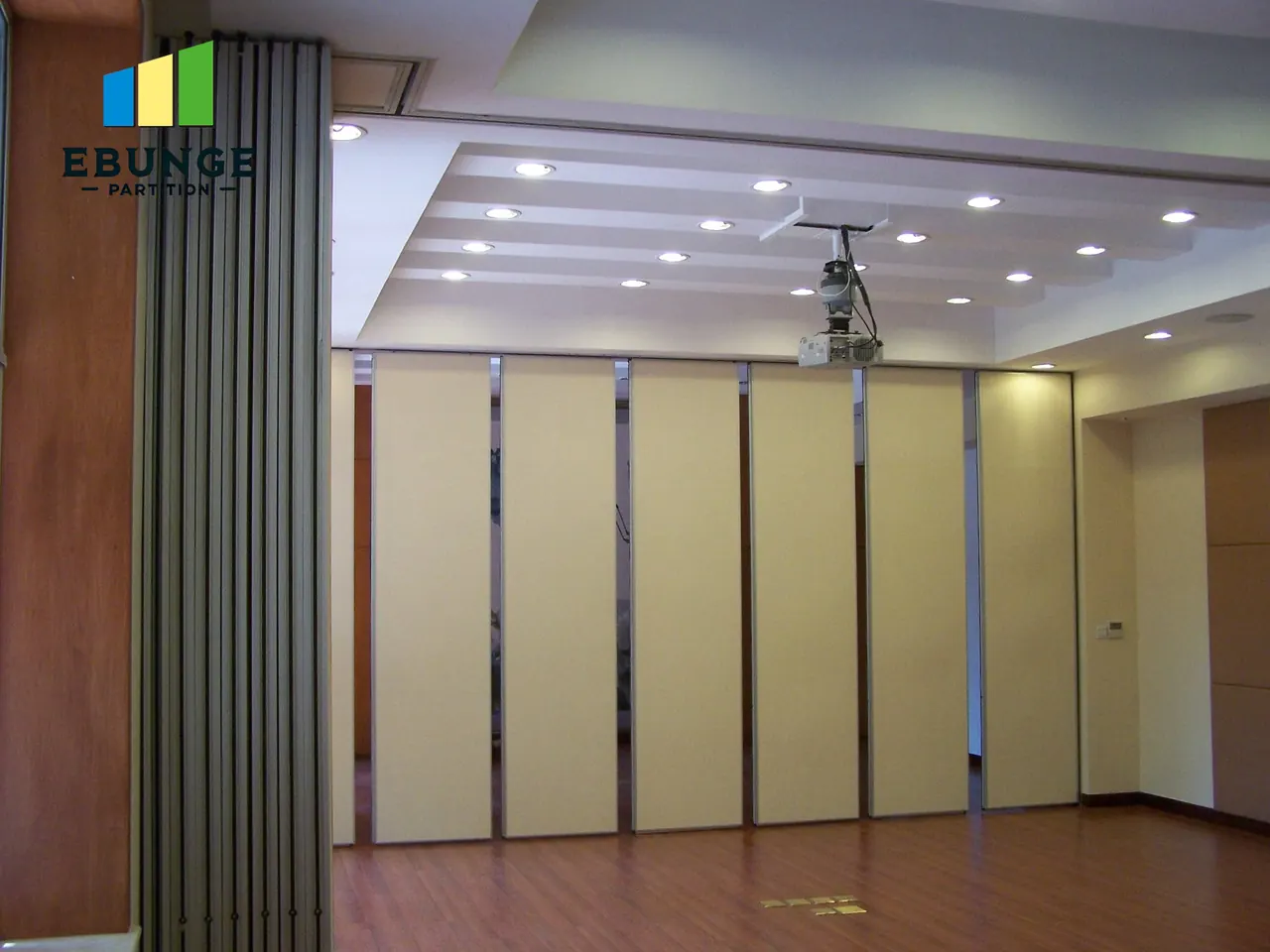 Movable partition panels and connected ceiling track near a stack