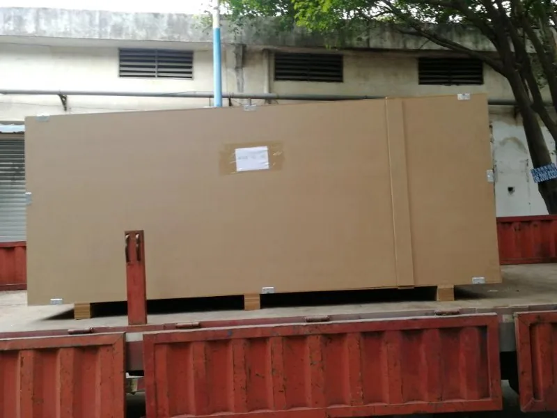 Long cardboard-wrapped crate staged for transport