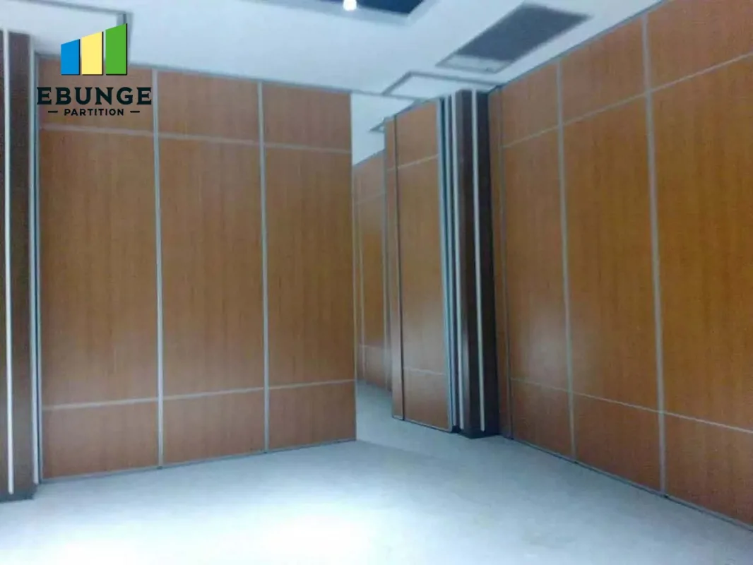 Wood finish operable wall panels forming two sides of a room