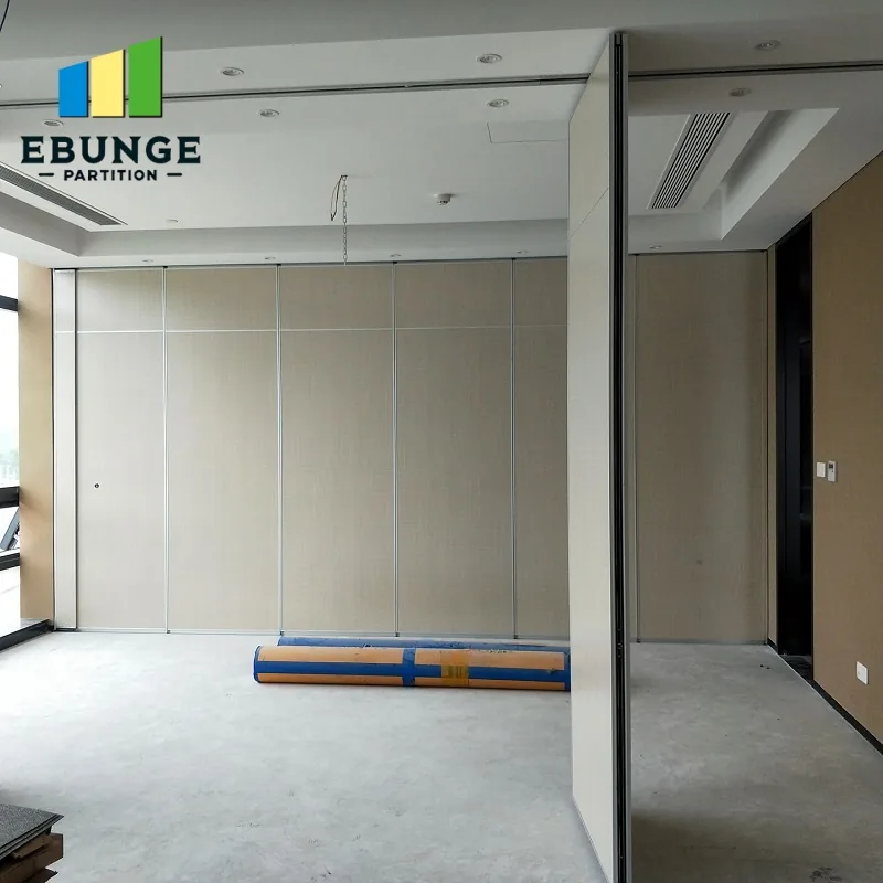 Real white movable partition at an unfinished room interface with ceiling track and pass door