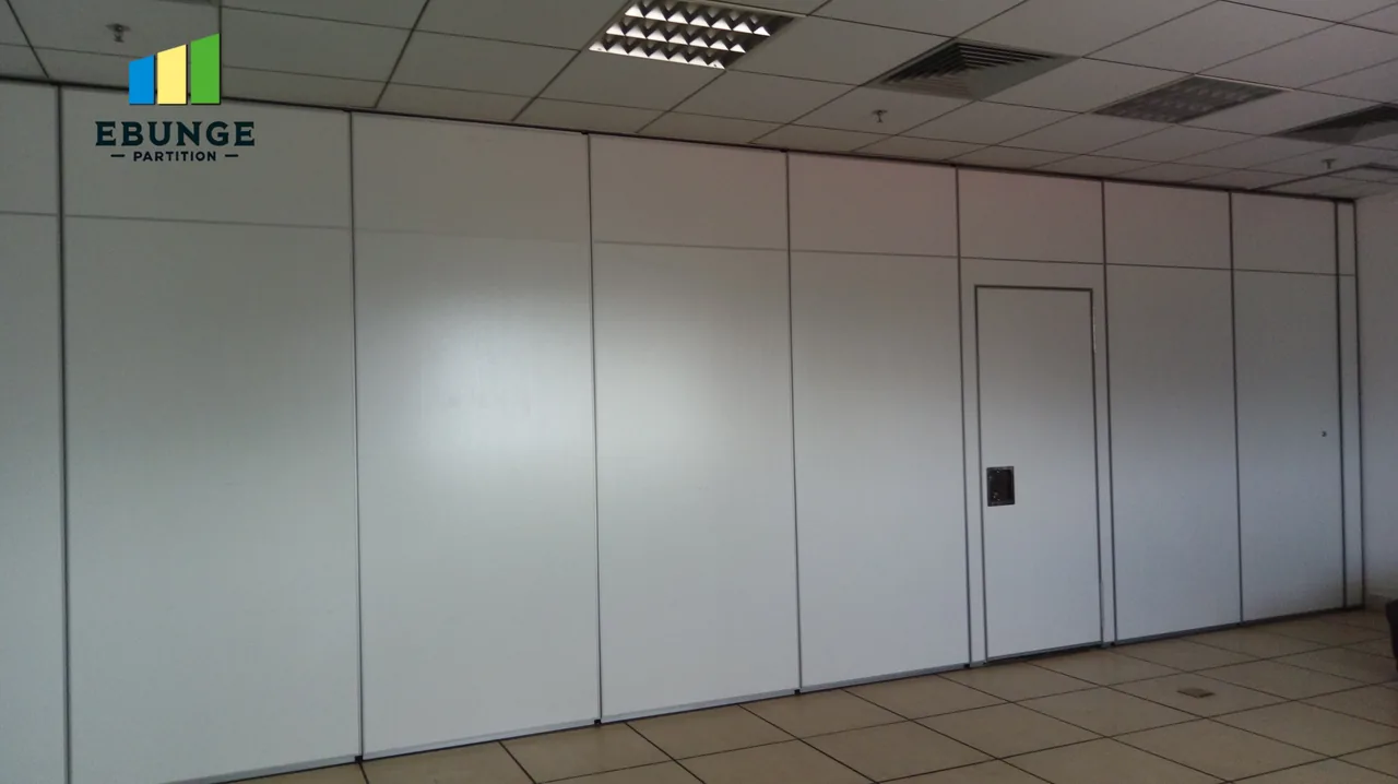 Real white movable partition with a visible pass door in a room