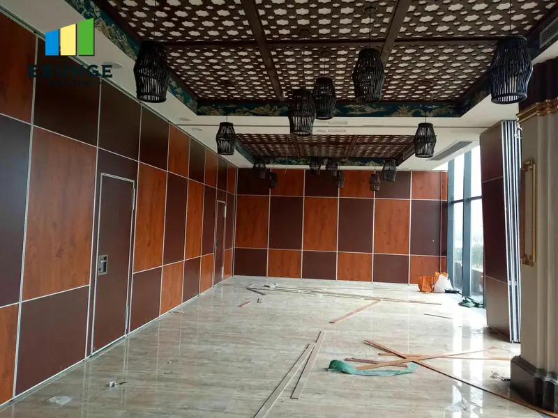 Real wood-look partition installation below a detailed ceiling in a room under completion