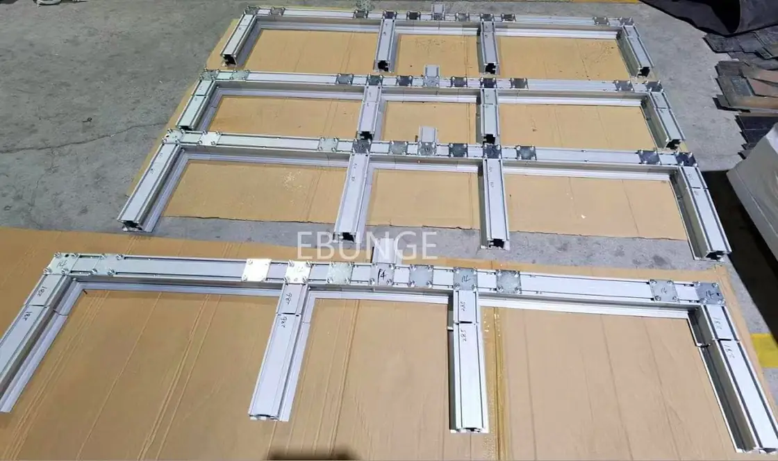 Real labeled aluminum movable partition track sections laid out before shipment